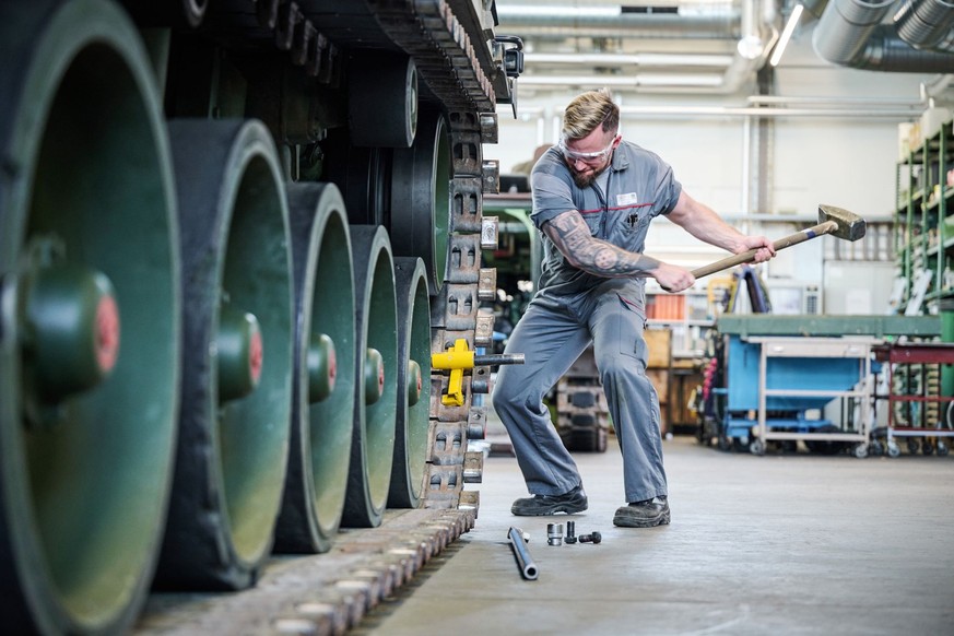 Mitarbeiter ALC, Gleiskette, Raupe, Raupenband, Vorschlaghammer, Reparatur, Instandhaltung, reparieren, schlagen, Kraft, Schwung, Panzermechaniker, Armeelogistikcenter Hinwil (ALC-H)