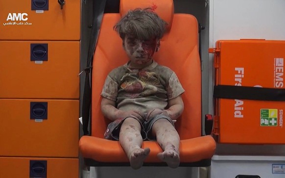 2016 AP YEAR END PHOTOS - In this frame grab taken from video provided by the Syrian anti-government activist group Aleppo Media Center (AMC), 5-year-old Omran Daqneesh sits in an ambulance after bein ...