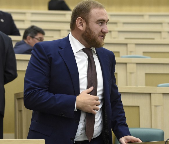 In this photo taken on Wednesday, Sept. 28, 2016, Rauf Arashukov, who represents the Karachaevo-Cherkessiya region in the North Caucasus, stands at the Federation Council, in Moscow, Russia. A Russian ...