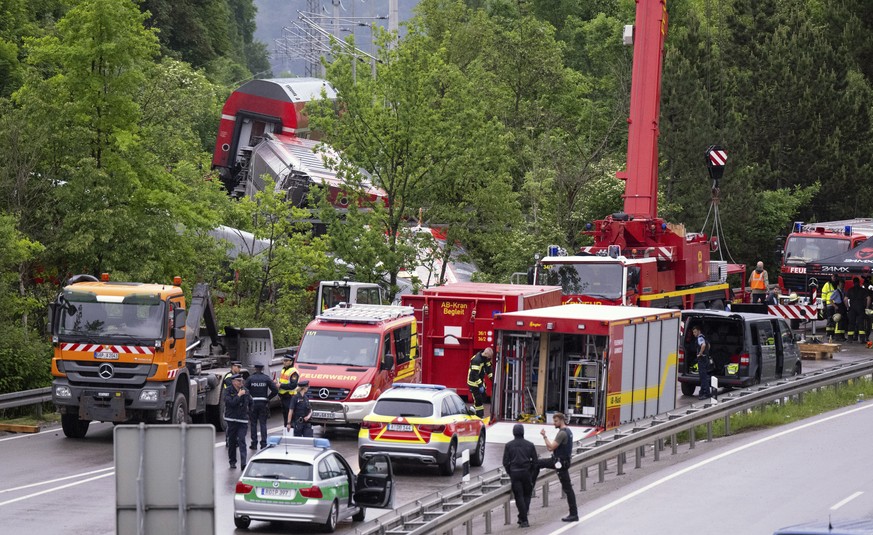Emergency and rescue forces work on the site of a train crash in Burgrain, Germany, Friday, June 3, 2022. Authorities say a train accident in the Alps in southern Germany on Friday left at least four  ...