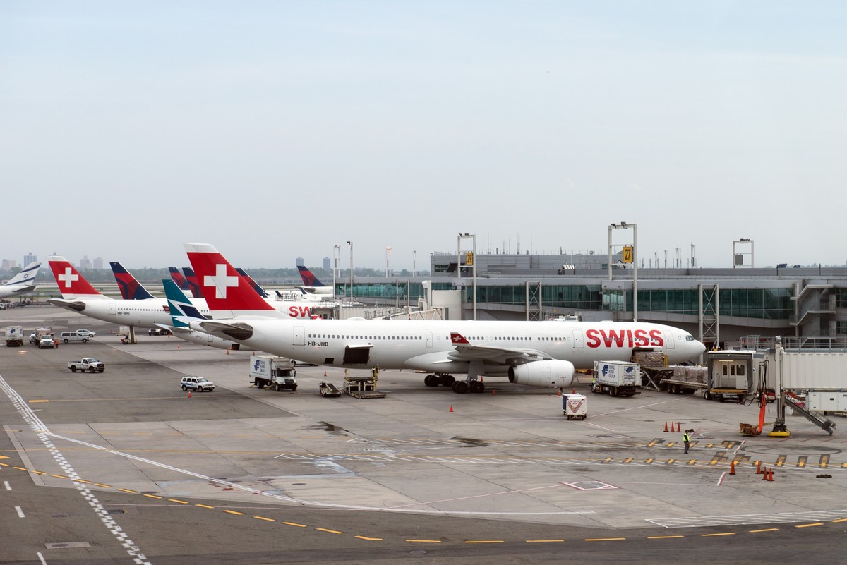 Delta Airlines and Swiss Airlines at JFK airport terminal, NEW YORK- MAY 15, 2018: Delta Airlines and Swiss Airlines planes on tarmac at Terminal 4 at JFK International Airport. JFK is one of the bigg ...