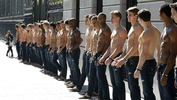 Bare-chested models pose in front of the Abercrombie &amp; Fitch shop on the Champs Elysees in Paris Thursday May 12, 2011, as of the promotion of the opening of the new U.S. brand shop in Paris.(AP P ...