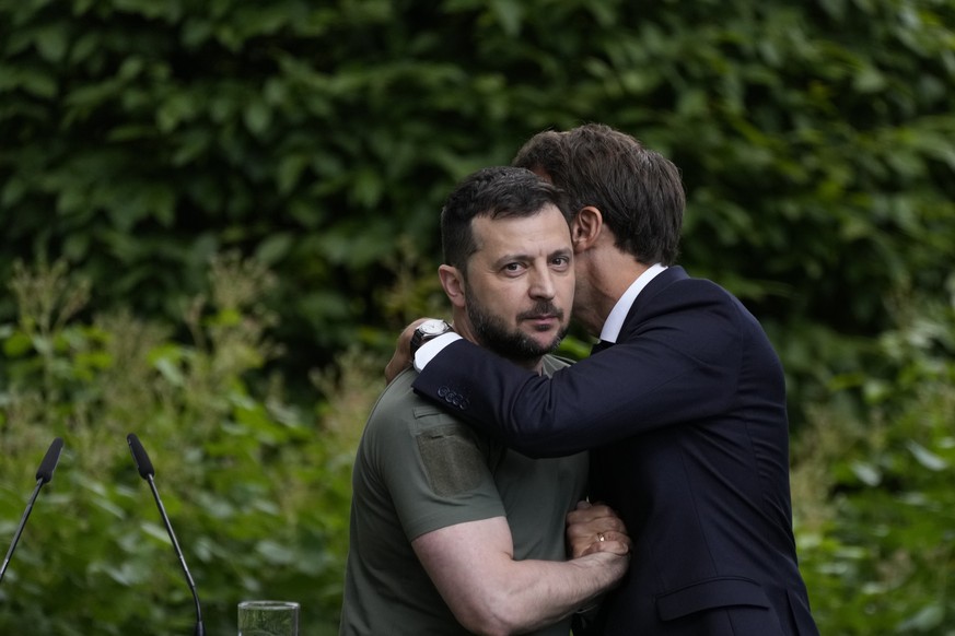 Ukraine President Volodymyr Zelenskyy, left, embraces France&#039;s President Emmanuel Macron at the end of a conference at the Mariyinsky palace in Kyiv, Ukraine, Thursday, June 16, 2022. (AP Photo/N ...