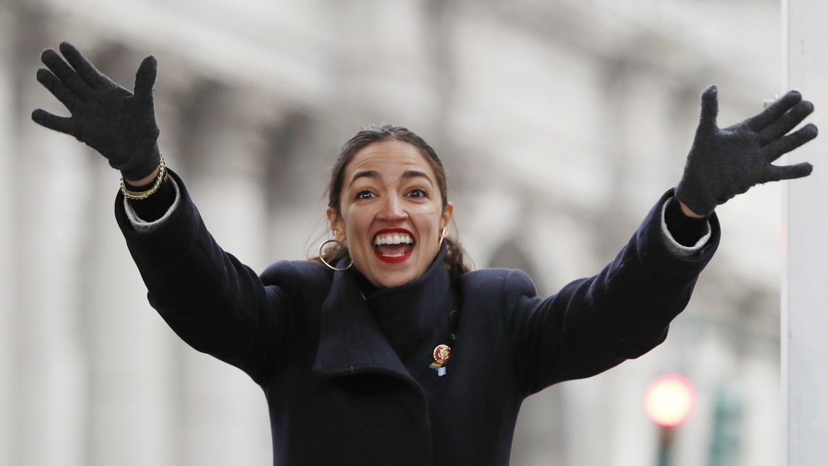 U.S. Rep. Alexandria Ocasio-Cortez, (D-New York) waves to the crowd as she steps onto the stage at the Women's Unity Rally organized by Women's March NYC in Lower Manhattan, Saturday, Jan. 1 ...