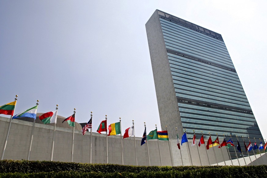 FILE - In this Sept. 13, 2005 file photo, the flags of member nations fly outside the General Assembly building at the United Nations headquarters in New York. The U.N. General Assembly overwhelmingly ...