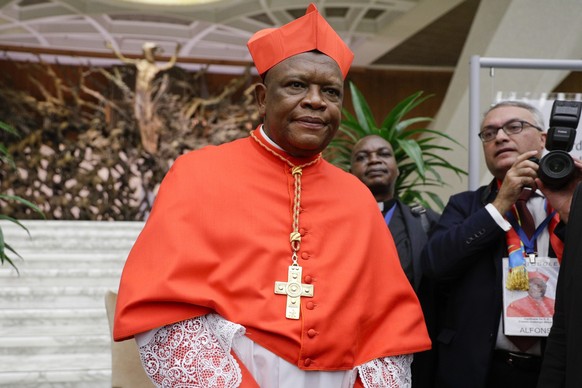 FILE - Cardinal Fridolin Among Besungu leaves after receiving the red three-cornered biretta hat from Pope Francis during a consistory inside St. Peter&#039;s Basilica, at the Vatican, Oct. 5, 2019. I ...