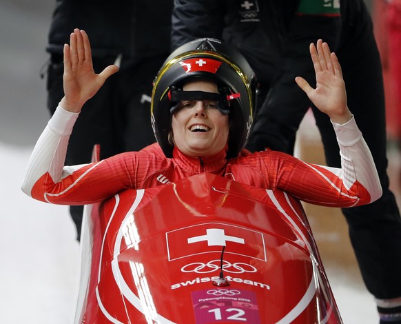 Driver Sabina Hafner and Rahel Rebsamen of Switzerland smile after their final heat during the women's two-man bobsled final at the 2018 Winter Olympics in Pyeongchang, South Korea, Wednesday, Feb. 21, 2018. (AP Photo/Andy Wong)