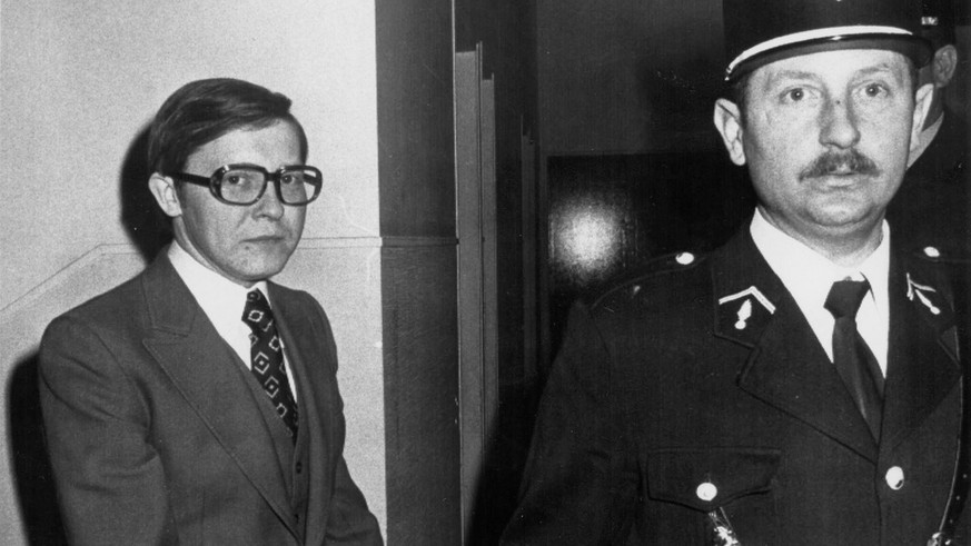 ** FILE ** Handcuffed Patrick Henry, left, is led by a gendarme to the court of Justice in Troyes, eastern France, in this Jan. 20 1977 file photo, on the third day of his trial for kidnapping and mur ...
