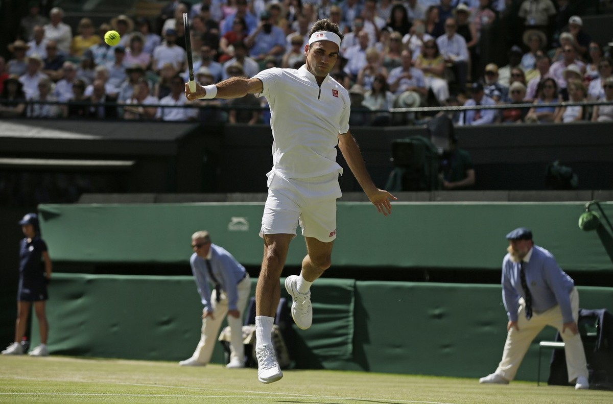 Switzerland's Roger Federer returns to Britain's Jay Clarke in a Men's singles match during day four of the Wimbledon Tennis Championships in London, Thursday, July 4, 2019. (AP Photo/T ...