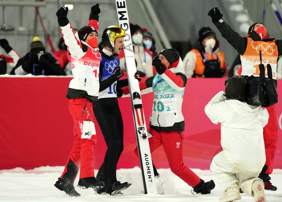 epa09755803 Manuel Fettner (2-L) of Austria celebrates with teammates after Austria won the Men&#039;s Team Ski Jumping Large Hill final at the Zhangjiakou National Ski Jumping Centre at the Beijing 2 ...