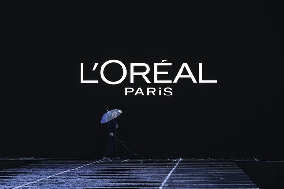 epa11621637 A staff member gets rid off the water on the runway before the start of the show for the Womenswear Spring/Summer 2025 collection of L&#039;Oreal Paris during the Paris Fashion Week, in Pa ...