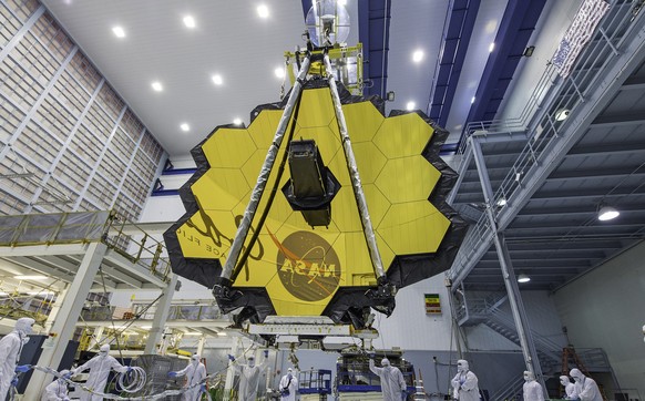 FILE - In this April 13, 2017 photo provided by NASA, technicians lift the mirror of the James Webb Space Telescope using a crane at the Goddard Space Flight Center in Greenbelt, Md. NASA announced Tu ...