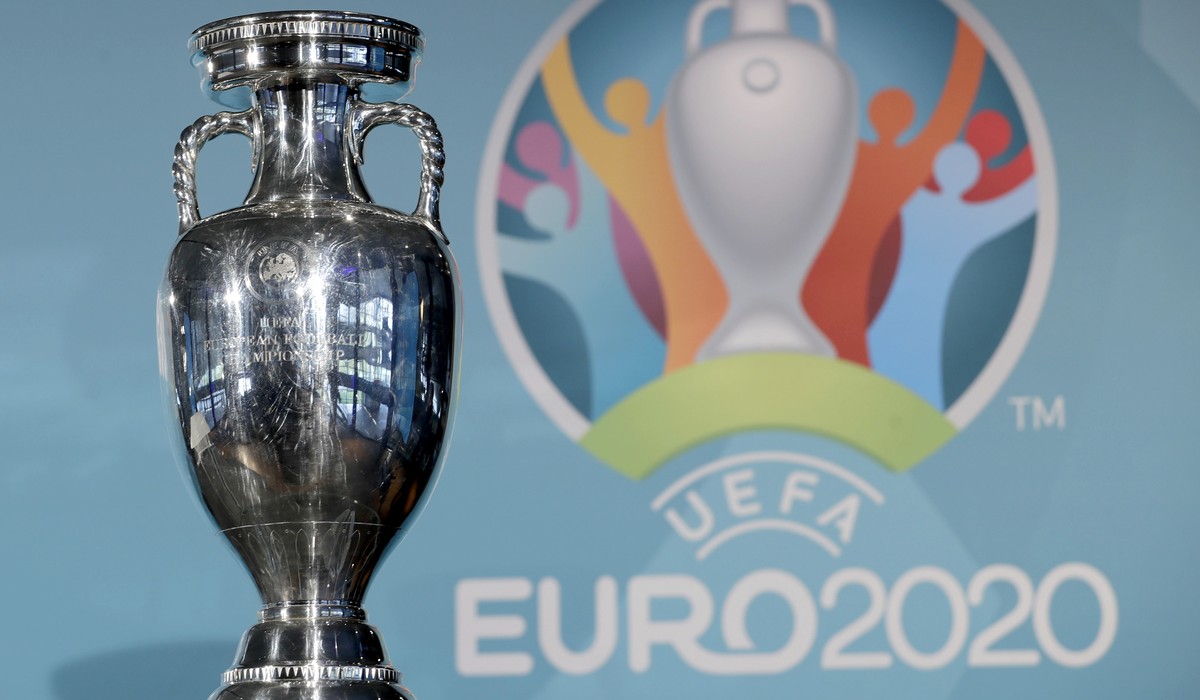 FILE - In this Thursday, Oct. 27, 2016 file photo the Euro soccer championships trophy is seen in front of the logo during the presentation of Munich's logo as one of the host cities of the Euro  ...