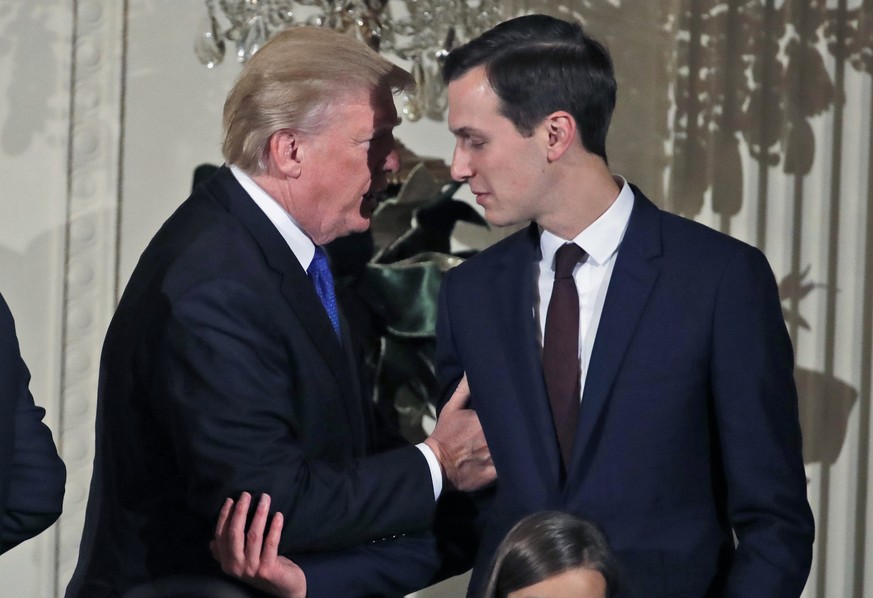 President Donald Trump speaks with White House Senior Adviser Jared Kushner as he departs after a Hanukkah reception in the East Room of the White House, Thursday, Dec. 7, 2017, in Washington. (AP Pho ...