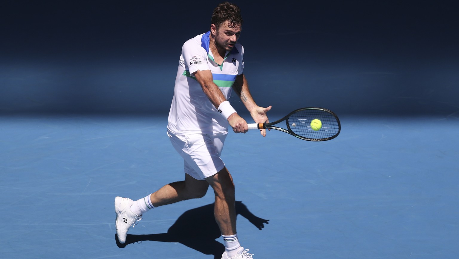 Switzerland&#039;s Stan Wawrinka makes a backhand return to Hungary&#039;s Marton Fucsovics during their second round match at the Australian Open tennis championship in Melbourne, Australia, Wednesda ...