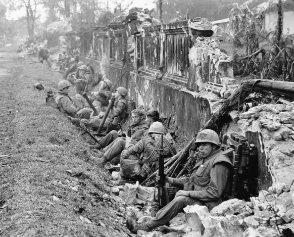 FILE - In this Feb. 1968, file photo, a unit of the 1st Battalion, 5th Regiment U.S. Marines, rests alongside a battered wall of Hue&#039;s imperial palace after a battle for the Citadel during the Te ...