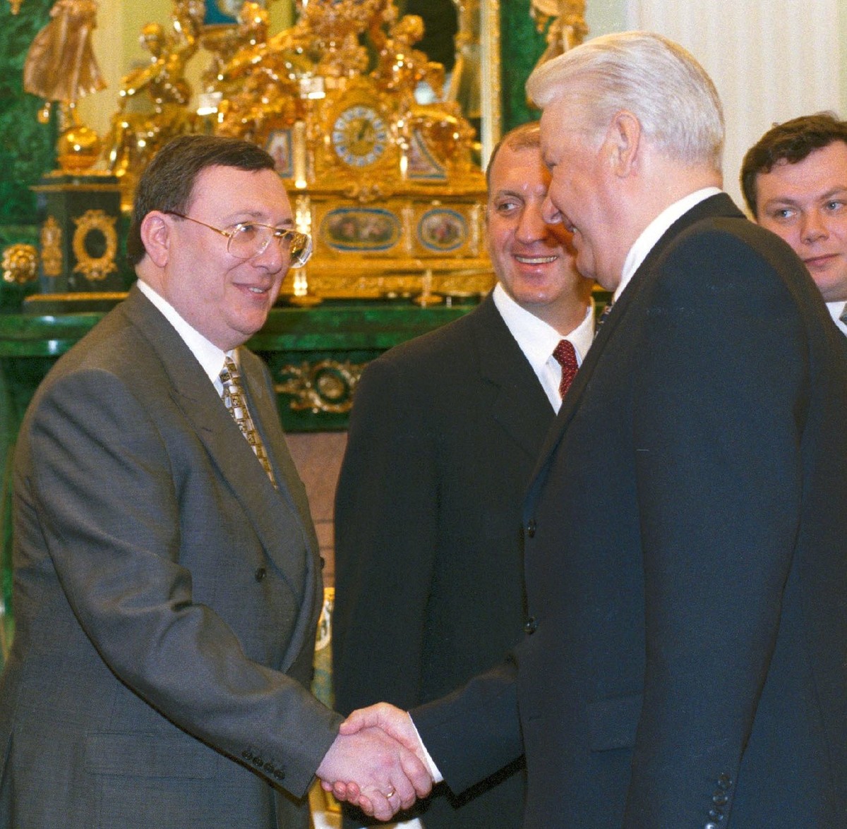 President Boris Yeltsin and Vladimir Gusinsky, left, owner of the Media-Most holding company, shaking hands at a meeting with Russia's most powerful businessmen in the Kremlin in Moscow. Media ty ...