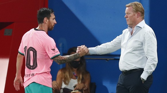 Barcelona's Lionel Messi, left, shakes hands as he is substituted with Barcelona's coach Ronald Koeman as he is substituted during the pre-season friendly soccer match between Barcelona and ...
