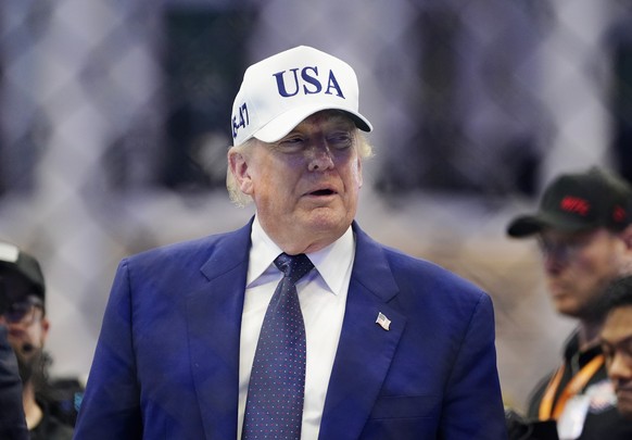 epa13038115 US President Donald Trump stands in the octagon after the UFC Freedom 250 event on the South Lawn of the White House in Washington, DC, USA, 15 June 2026. The mixed martial arts bouts are  ...