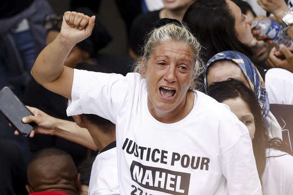 epa10717503 Nahel&#039;s mother, wearing a &#039;Justice for Nahel&#039; T-shirt, raises her fist as she attends a march in the memory of her 17-year-old son who was killed by French Police in Nanterr ...