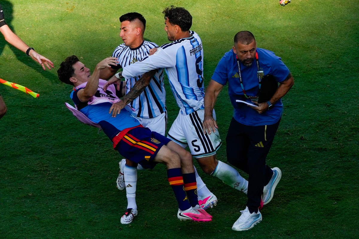 Spain's Gavi, left, falls as he scuffles with Argentina's Leandro Paredes (5) and Thiago Almada during the World Cup final soccer match between Spain and Argentina in East Rutherford, N.J.,  ...