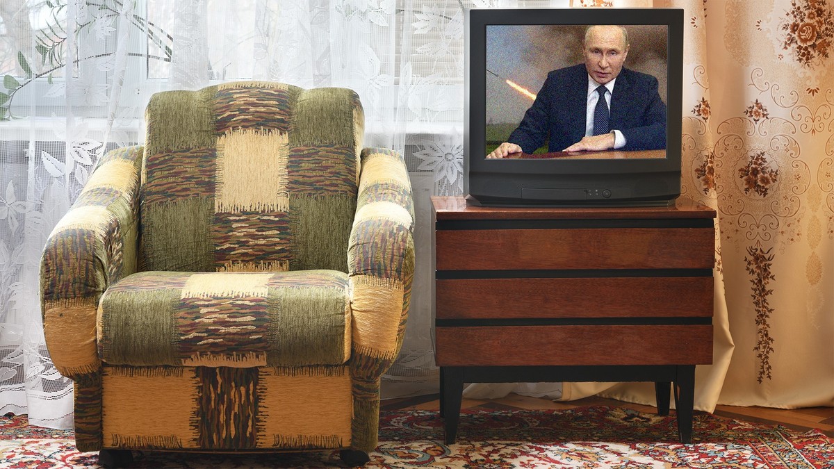 Old TV with white screen on a vintage wooden cabinet, old design in an apartment in the style of the 1980s and 1990s. Interior in the style of the USSR.