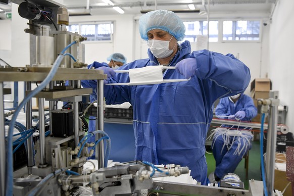 epa08323896 Detainees make medical face masks at the Hajdu-Bihar County Penitentiary in Debrecen, Hungary, 26 March 2020. Protective masks are manufactured 24 hours a day. Eight tons of raw material f ...