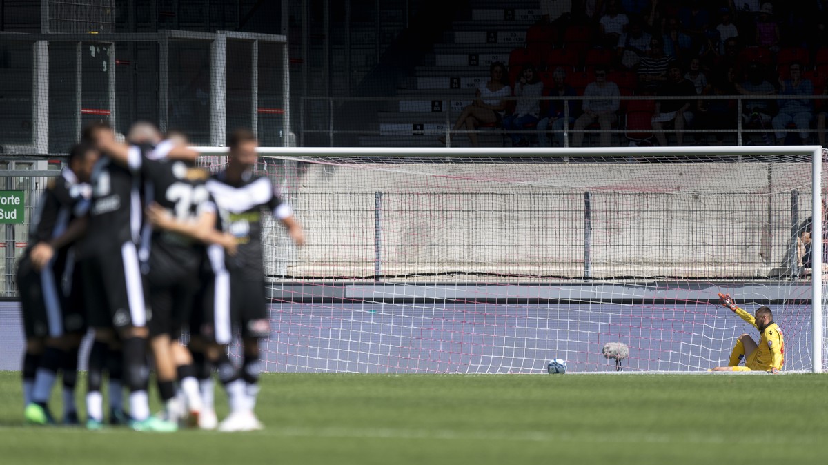 Les joueurs luganais celebrent le premier but devant le gardien valaisan Anthony Maisonnial, droite, lors de la rencontre de football de Super League entre le FC Sion et FC Lugano ce dimanche 22 juill ...