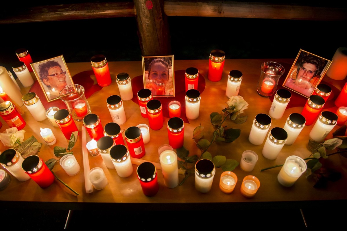 Portraits of three women who were killed and candles are pictured during a walk in tribute to the victims in the street of Daillon, Switzerland, Saturday, January 5, 2013. Late Wednesday, January 2, a ...