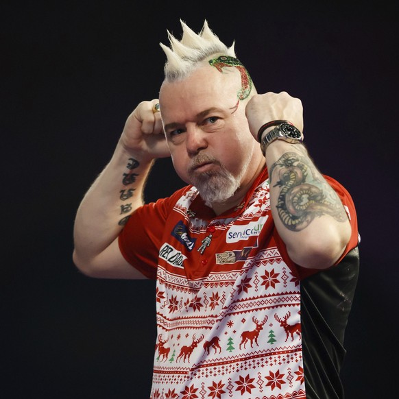 Scotland&#039;s Peter Wright celebrates his victory in his match against Diogo Portela of Brazil during day eight of the World Darts Championship at Alexandra Palace, London, Thursday Dec. 21, 2017. ( ...