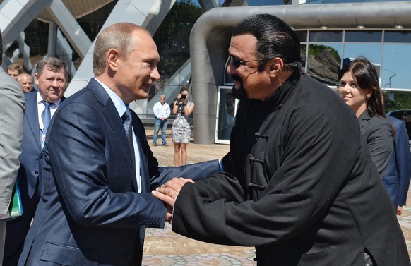 epa05615777 A picture dated 04 September 2015 and released on 03 November 2016 shows Russian President Vladimir Putin (L) shaking hands with US actor Steven Seagal (R) while visiting an oceanarium at  ...