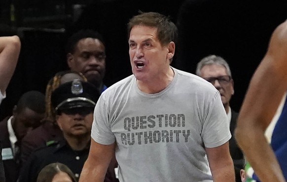 Dallas Mavericks owner Mark Cuban, center right, yells at referee Evan Scott, center left, during the second half of an NBA basketball game against the Charlotte Hornets in Dallas, Friday, March 24, 2 ...