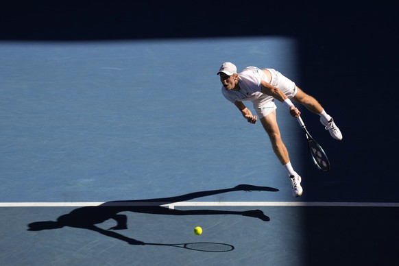 Denis Shapovalov of Canada serves to Reilly Opelka of the U.S. during their third round match at the Australian Open tennis championships in Melbourne, Australia, Friday, Jan. 21, 2022. (AP Photo/Simo ...