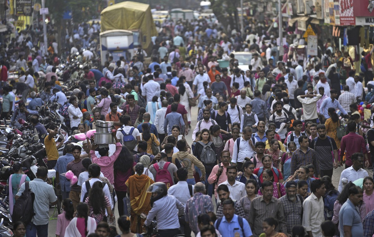 A crowd walks in a market area outside Dadar station in Mumbai, India, Friday, March 17, 2023. India will soon eclipse China to become the world's most populous country, and its economy is among  ...