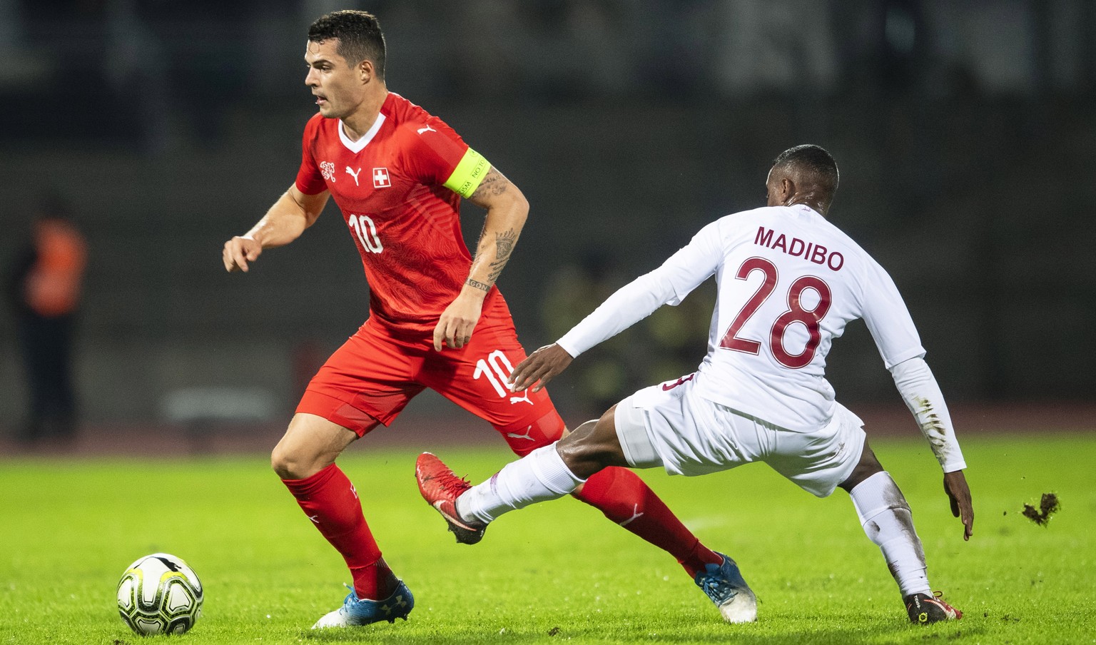 epa07165392 Qatar&#039;s Assim Madibo (R) in action against Switzerland&#039;s Granit Xhaka (L) during the International Friendly soccer match between Switzerland and Qatar in Lugano, Switzerland, 14  ...