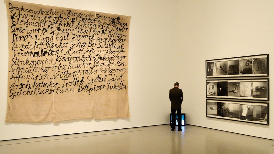 epa04160677 A man stands in front a tv showing a video as part of the artworks displayed in a major retrospective exhibition of German artist Sigmar Polke entitled &#039;Alibis: Sigmar Polke 1963â€“20 ...