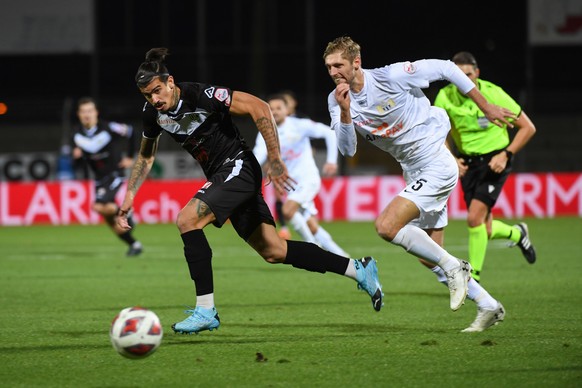 Lugano ?s player Joaquin Ardaiz and Zuerich ?s player Lasse Sobiech, right, during the Super League soccer match FC Lugano against FC Zuerich, at the Cornaredo stadium in Lugano, Sunday, December 13,  ...