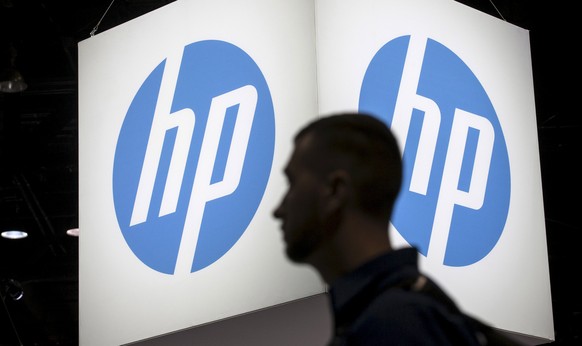 An attendee at the Microsoft Ignite technology conference walks past the Hewlett-Packard (HP) logo in Chicago, Illinois in this May 4, 2015 file photo. REUTERS/Jim Young/Files GLOBAL BUSINESS WEEK AHE ...