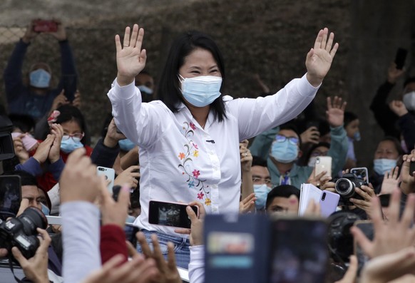 Presidential candidate Keiko Fujimori waves at supporters after casting her vote in Lima, Peru, Sunday, June 6, 2021. Peruvians head to the polls in a presidential run-off election to choose between F ...
