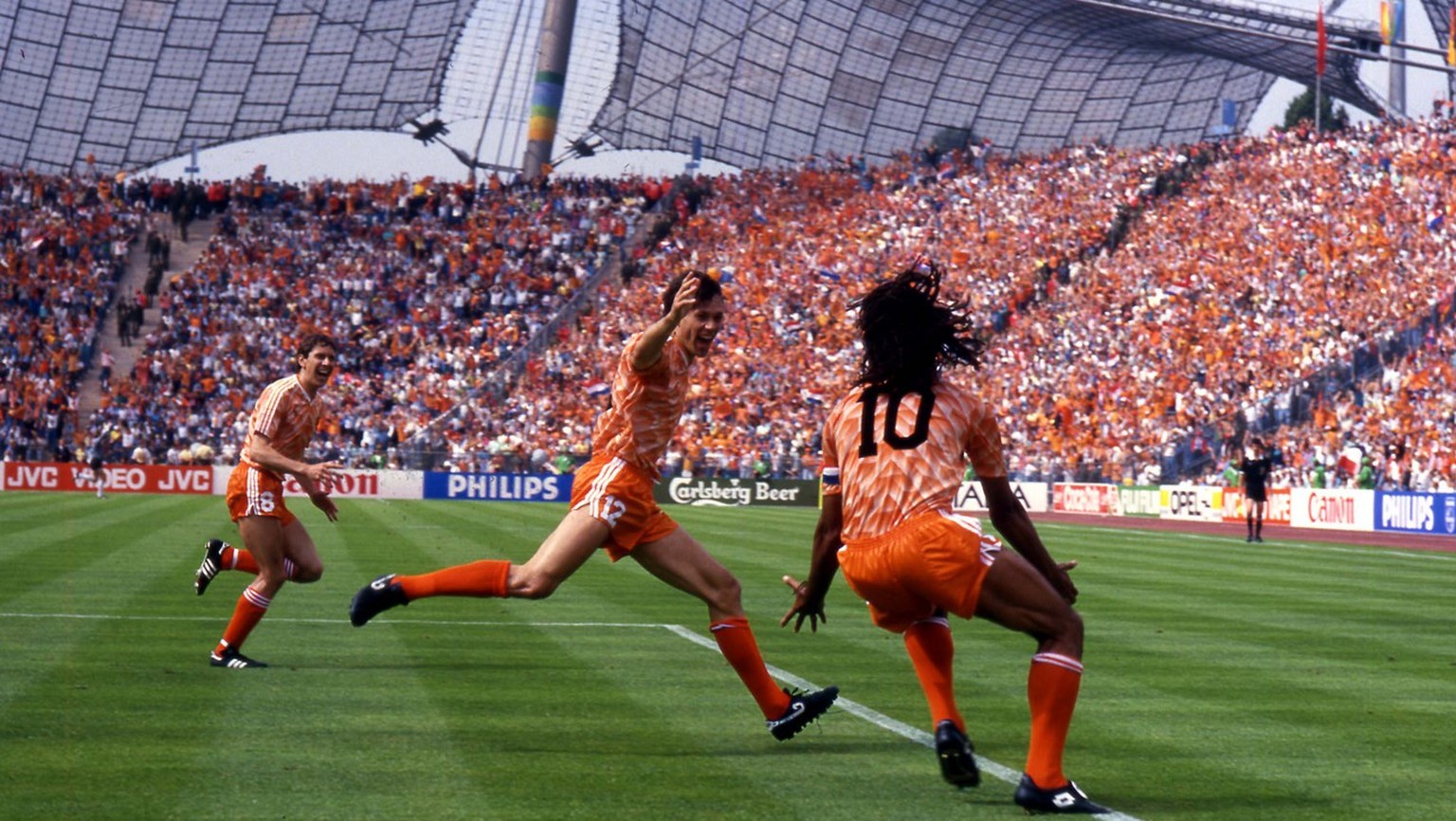 Marco Van Basten, at center, of the Netherlands soccer team celebrate with teammate Ruud Gullit, right, after scoring the winning goal during the final game of the European soccer Championships, on Ju ...