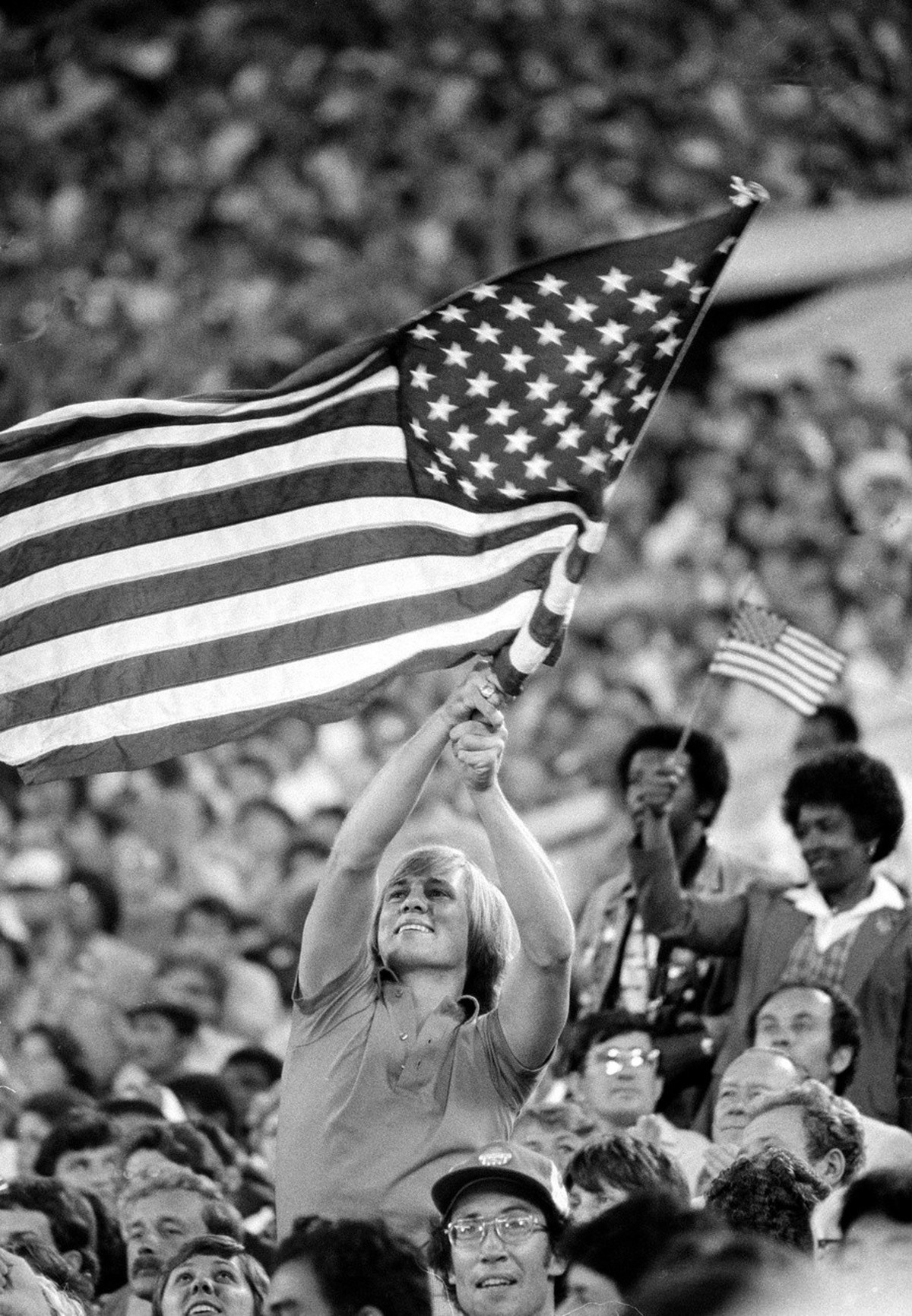 Chuck Maslim of Parryman, Md., waves a large American flag from the stands of Lenin Stadium during closing ceremonies of the 1980 Moscow Summer Olympic Games in Moscow, Sunday, Aug. 3, 1980. The Unite ...