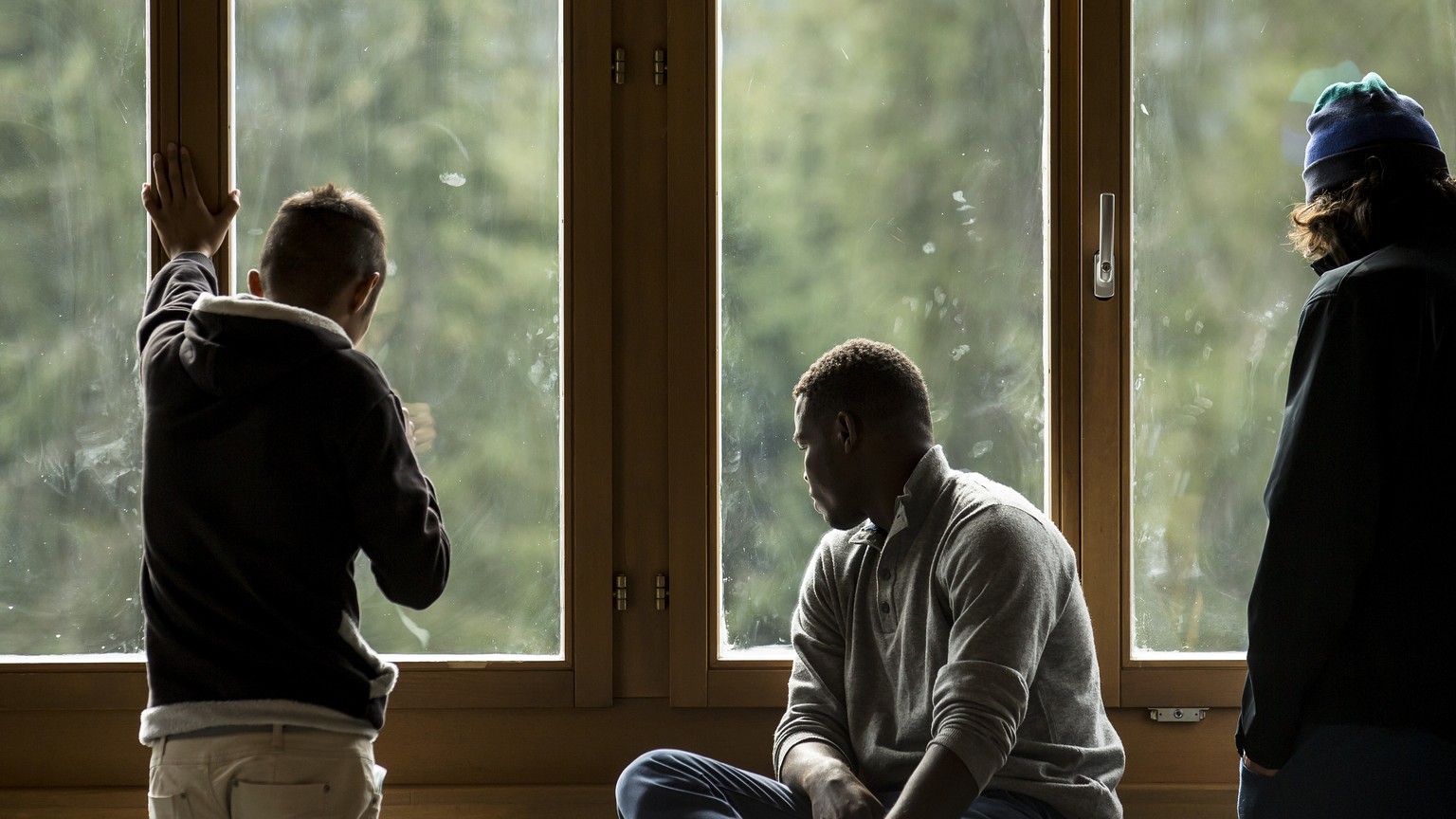 Maenner schauen aus dem Fenster anlaesslich des Informationstag fuer die Bevoelkerung im Bundesasylzentrum Glaubenberg am Samstag, 1. Oktober 2016. Der Kanton Obwalden und die Gemeinde Sarnen hatten s ...