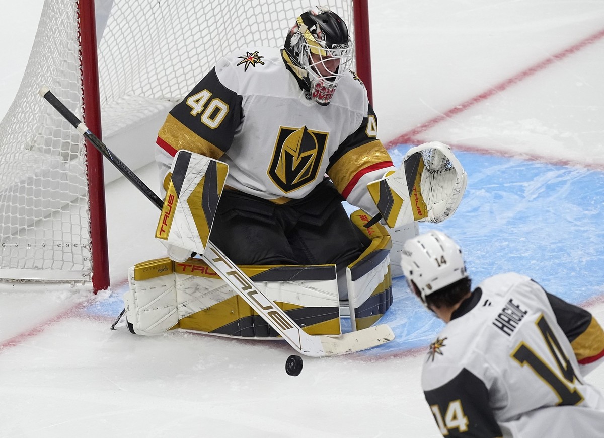 Vegas Golden Knights goalie Akira Schmid makes a stick save against the Colorado Avalanche in the third period of an NHL preseason hockey game Tuesday, Oct. 1, 2024, in Denver. (AP Photo/David Zalubow ...