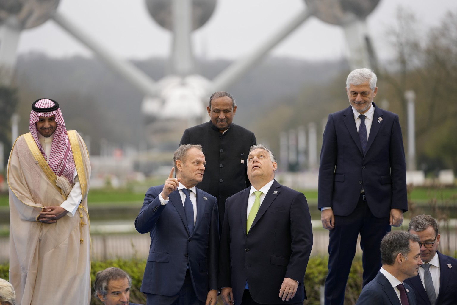 Hungary&#039;s Prime Minister Viktor Orban, center right, speaks with Poland&#039;s Prime Minister Donald Tusk, center left, as they pose for a group photo in front of the Atomium during an Nuclear En ...