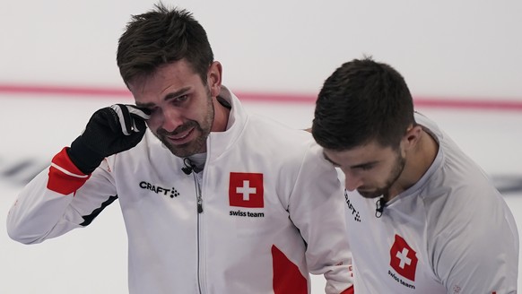 Switzerland&#039;s Peter De Cruz, left, tears up and hugs teammate Pablo Lachat, right, after a win against Sweden during a men&#039;s curling match at the Beijing Winter Olympics Thursday, Feb. 17, 2 ...