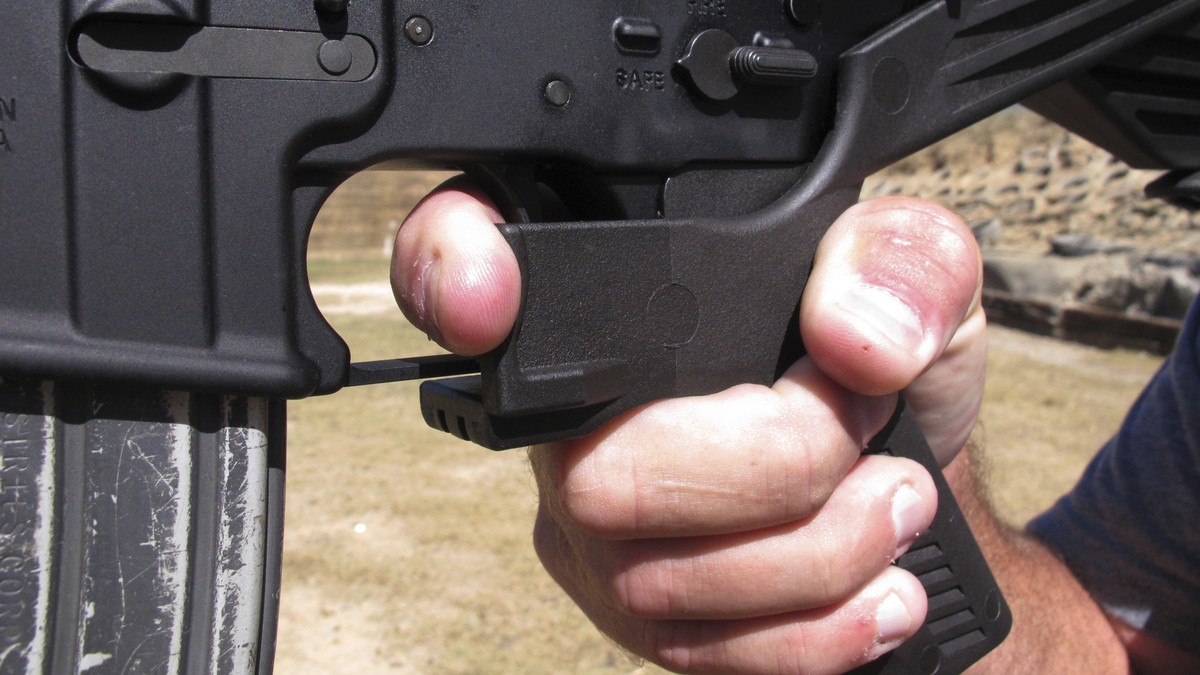 FILE - In this Oct. 4, 2017, file photo, shooting instructor Frankie McRae demonstrates the grip on an AR-15 rifle fitted with a bump stock at his 37 PSR Gun Club in Bunnlevel, N.C. The largest gun in ...