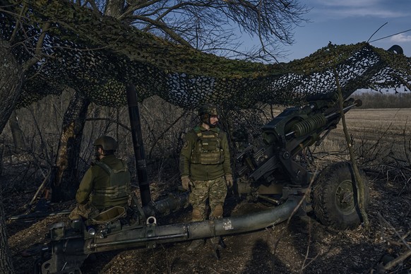 Ukrainian soldiers look on from their position on the frontline in Bakhmut, Donetsk region, Ukraine, Wednesday, March 22, 2023.(AP Photo/Libkos)