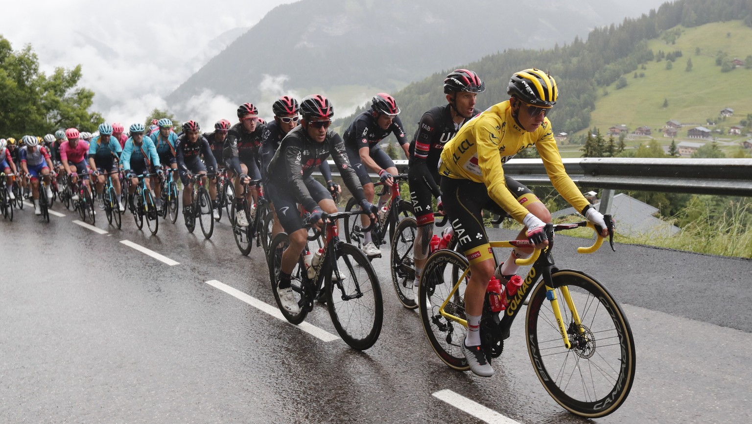 epa09322115 Slovenian rider Tadej Pogacar (R) of the UAE-Team Emirates in action during the 9th stage of the Tour de France 2021 over 144.9 km from Cluses to Tignes, France, 04 July 2021. EPA/GUILLAUM ...