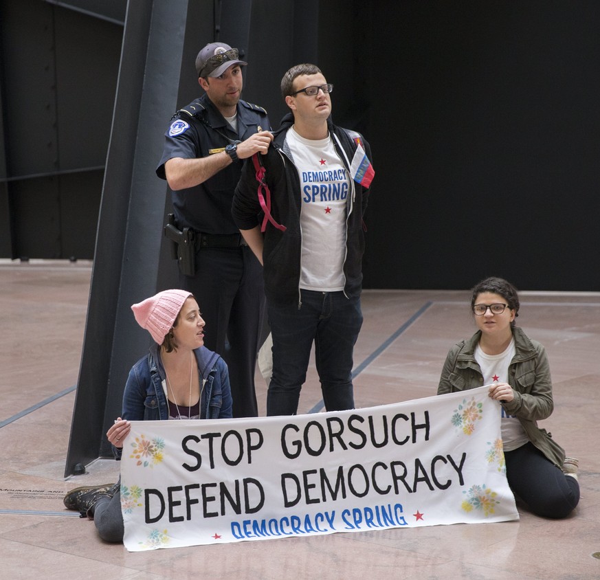 epa05892375 Protesters are arrested for rallying in the Hart Senate Office Building against the confirmation of Supreme Court nominee Judge Neil Gorsuch in Washington, DC, USA, 06 April 2017. Senate M ...