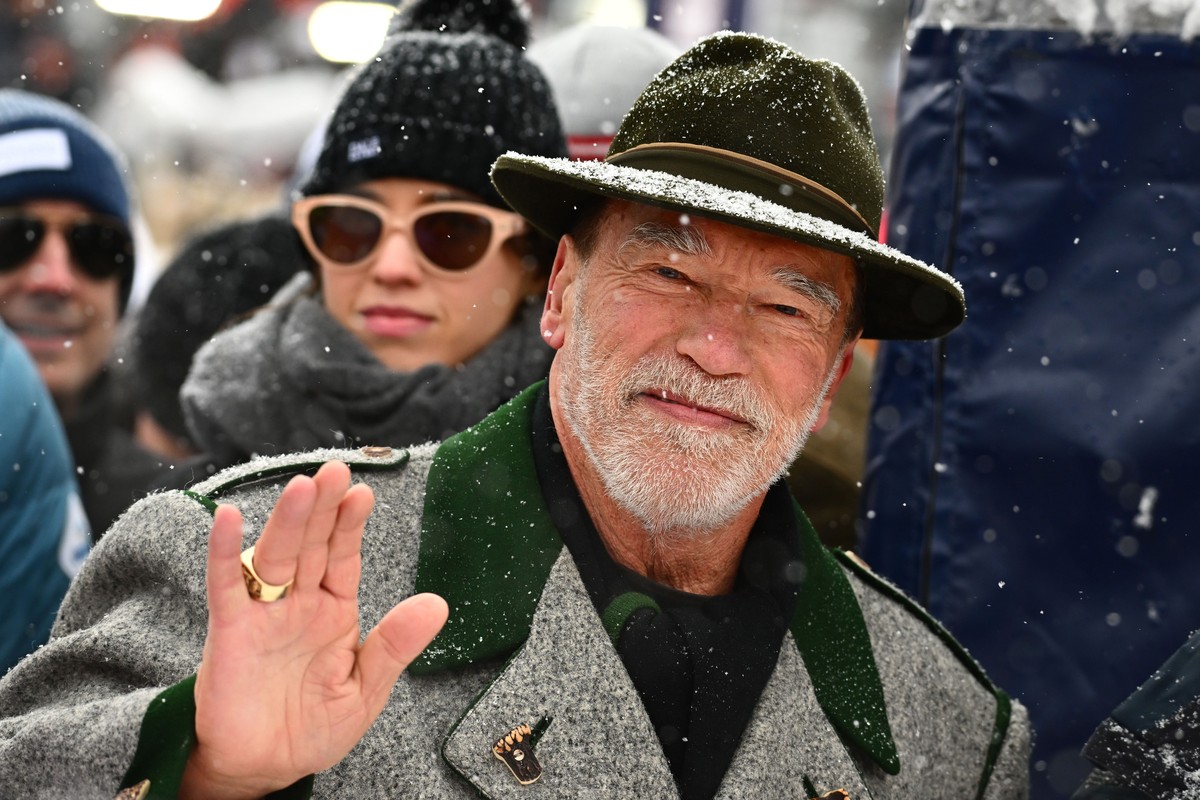 epa10420175 Austrian-born actor and former US Governor of California, Arnold Schwarzenegger react in the stands during the Men's Downhill race of the FIS Alpine Skiing World Cup at the Streif ski ...